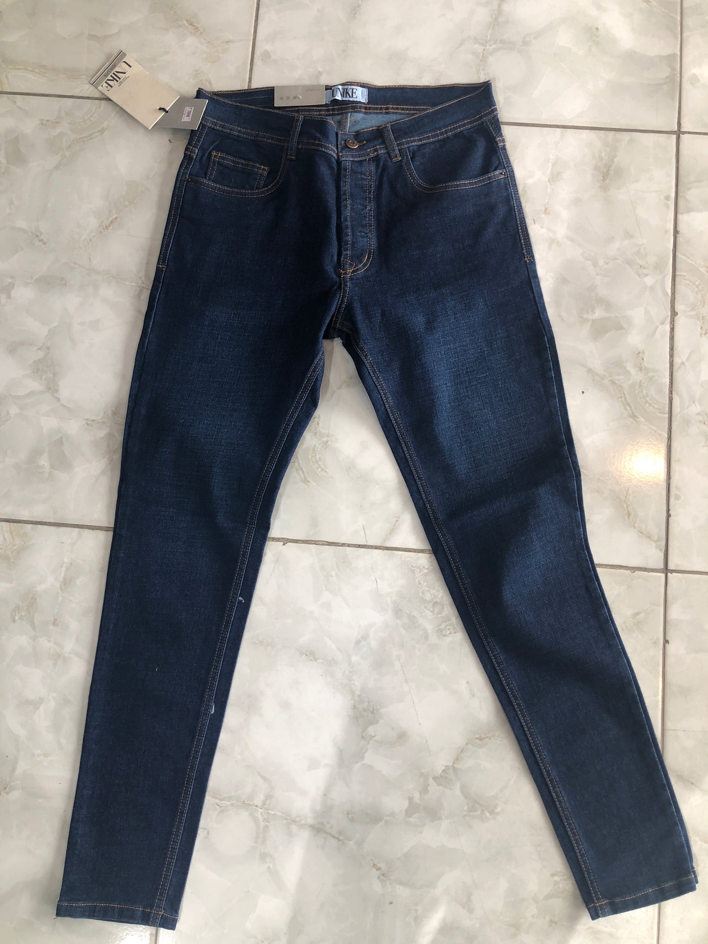 Jean caballero azul petroleo liso borde café